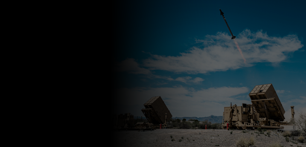 Website banner with dark gradient and missile launching in the background.